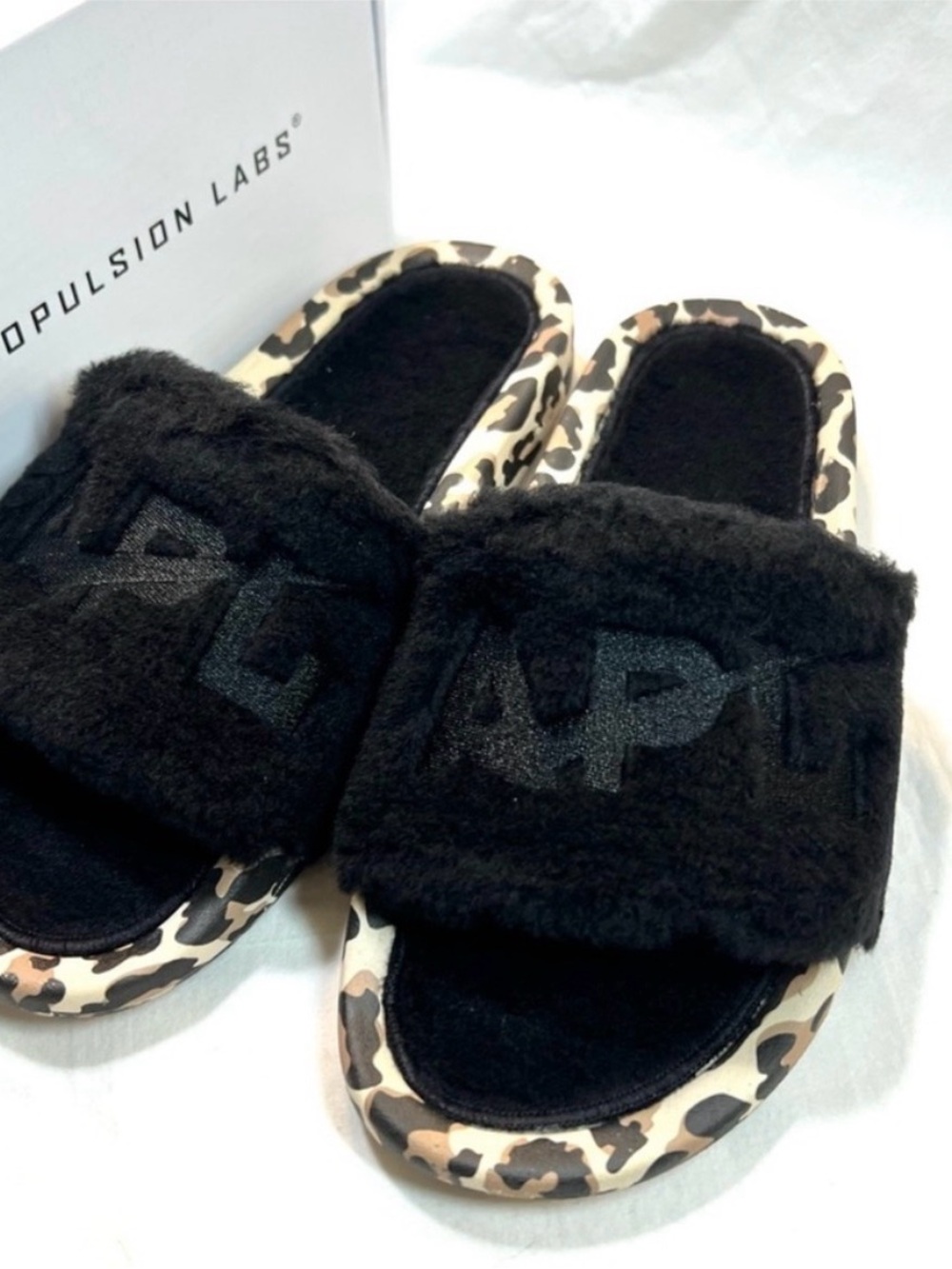 APL Black Fur lined Slides with Leopard Print Sole in women’s size 8.